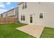 Home's backyard with artificial turf and patio at 36 Schoolhouse Way, Clayton, NC 27520