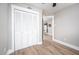 Bedroom with louvered closet doors and view into adjacent kitchen at 3805 Chimney Ridge Pl # 008, Durham, NC 27713