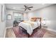 Cozy bedroom with ceiling fan, large window, and neutral color scheme at 3805 Chimney Ridge Pl # 008, Durham, NC 27713