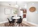 Bright dining area with white table and four black chairs, situated near the kitchen at 3805 Chimney Ridge Pl # 008, Durham, NC 27713