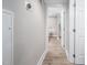 Clean hallway with light walls and laminate wood flooring, leading to bedrooms and bath at 3805 Chimney Ridge Pl # 008, Durham, NC 27713