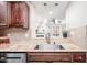 Modern kitchen features granite countertops, stainless steel sink, and dark wood cabinets at 3805 Chimney Ridge Pl # 008, Durham, NC 27713
