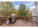 Outdoor deck features a stainless steel grill, wooden railings, and a tranquil wooded backdrop at 3905 Song Sparrow Dr, Wake Forest, NC 27587