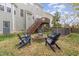 Backyard features a fire pit with Adirondack chairs, hot tub and wooden fence at 3905 Song Sparrow Dr, Wake Forest, NC 27587