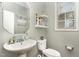 Cozy half bath with gray walls, white fixtures, and decorative accents at 3905 Song Sparrow Dr, Wake Forest, NC 27587