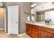 Bathroom features a double sink vanity with wooden cabinets and a framed mirror at 3905 Song Sparrow Dr, Wake Forest, NC 27587