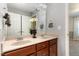 Bathroom with double sink vanity, wooden cabinets, neutral walls, and a walk-in shower at 3905 Song Sparrow Dr, Wake Forest, NC 27587
