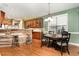 An eat-in kitchen and dining area with bar stool seating and hardwood floors at 3905 Song Sparrow Dr, Wake Forest, NC 27587