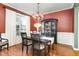 Formal dining room with elegant chandelier, hardwood floors, and a large window for natural light at 3905 Song Sparrow Dr, Wake Forest, NC 27587