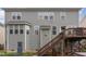 Back exterior of home features gray siding, and stairs leading to deck area at 3905 Song Sparrow Dr, Wake Forest, NC 27587