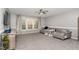 Living room with gray walls, plush carpeting, and a large window with natural light at 3905 Song Sparrow Dr, Wake Forest, NC 27587