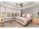 Serene main bedroom with a tray ceiling, large windows, and plush carpeting at 3905 Song Sparrow Dr, Wake Forest, NC 27587