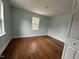 Well-lit bedroom with hardwood floors and window at 401 Commonwealth St St, Durham, NC 27703