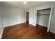Bedroom with hardwood floors and access to closet at 401 Commonwealth St St, Durham, NC 27703