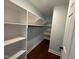 Large walk-in closet with built-in shelving at 401 Commonwealth St St, Durham, NC 27703