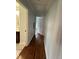 Bright hallway with hardwood floors and doors to bedrooms at 401 Commonwealth St St, Durham, NC 27703
