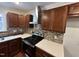 Modern kitchen with dark wood cabinets and quartz countertops at 401 Commonwealth St St, Durham, NC 27703