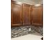 Dark wood cabinets and tile backsplash in kitchen at 401 Commonwealth St St, Durham, NC 27703