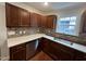 Modern kitchen with dark wood cabinets and quartz countertops at 401 Commonwealth St St, Durham, NC 27703