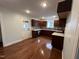 L-shaped kitchen with hardwood floors and island at 401 Commonwealth St St, Durham, NC 27703