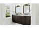 Double vanity bathroom with dark brown cabinets and marble flooring at 4081 Elk Creek Ln # 07, Raleigh, NC 27612