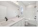 Bright bathroom featuring double sinks, quartz counters, and a shower-tub combo with black fixtures at 515 Wendover Pkwy, Pittsboro, NC 27312