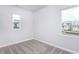 Bright bedroom with carpet flooring and two windows offering natural light at 515 Wendover Pkwy, Pittsboro, NC 27312