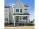 Charming two-story home with light blue siding, large windows, and a welcoming front porch at 515 Wendover Pkwy, Pittsboro, NC 27312