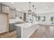 Open kitchen featuring a large island, gray cabinets, and stainless steel appliances at 515 Wendover Pkwy, Pittsboro, NC 27312