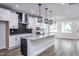 Modern kitchen with white cabinets, large island, and black accents at 515 Wendover Pkwy, Pittsboro, NC 27312