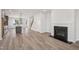 Open-concept living room flowing into the kitchen, featuring a cozy fireplace at 515 Wendover Pkwy, Pittsboro, NC 27312