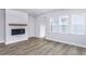 Bright living room with fireplace and wood-look floors at 515 Wendover Pkwy, Pittsboro, NC 27312