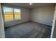Well-lit bedroom with carpeted floor and window view at 52 Faucette Dr, Selma, NC 27576