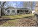 Gray house with front porch and landscaping at 5705 Larchwood Dr, Raleigh, NC 27609