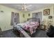 Bedroom with floral bedding, ceiling fan, and unique decor at 620 S Mebane St, Burlington, NC 27215