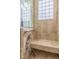 Bathroom with tiled shower, bench, and handrail at 6328 Nowell Pointe Dr, Raleigh, NC 27607