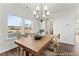 Dining room with hardwood floors, large table, chandelier, and view of backyard at 292 Nathan Dr # 46P, Lillington, NC 27546