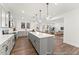 Modern kitchen with gray cabinets, large island, and stainless steel appliances at 292 Nathan Dr # 46P, Lillington, NC 27546