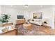 Living room with light walls, comfortable sofa, coffee table and large artwork at 292 Nathan Dr # 46P, Lillington, NC 27546
