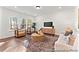 Bright living room with hardwood floors, comfy seating, and large windows at 292 Nathan Dr # 46P, Lillington, NC 27546