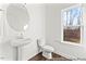 Clean powder room with pedestal sink and window at 292 Nathan Dr # 46P, Lillington, NC 27546