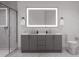 Bathroom with double vanity, a large mirror, and a walk-in shower at 711 E Lenoir St # 207, Raleigh, NC 27601