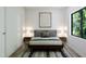 Spacious bedroom with a wood bed frame and large window at 711 E Lenoir St # 207, Raleigh, NC 27601