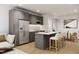 Open concept kitchen featuring gray cabinets and a breakfast bar at 711 E Lenoir St # 207, Raleigh, NC 27601