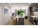 Modern kitchen with island, stainless steel appliances, and gray cabinetry at 711 E Lenoir St # 207, Raleigh, NC 27601
