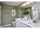 Double vanity bathroom with white cabinets and a walk-in shower at 769 Denburn Pl, Raleigh, NC 27603
