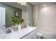 Clean bathroom with double vanity, bathtub, and green accents at 769 Denburn Pl, Raleigh, NC 27603