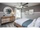 Bright bedroom featuring a wooden bed frame and a large round mirror at 769 Denburn Pl, Raleigh, NC 27603