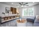 Spacious bonus room with large windows, grey sectional sofa, and ceiling fan at 769 Denburn Pl, Raleigh, NC 27603