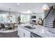 Open kitchen with granite island and a view into the living room and dining area at 769 Denburn Pl, Raleigh, NC 27603